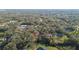 Aerial drone shot featuring parcel with nearby houses and bordering trees at 4075 Davis Rd, Mulberry, FL 33860