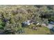 Aerial shot displaying a home shaded by trees and a swing hanging from a sturdy branch at 4075 Davis Rd, Mulberry, FL 33860