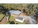 Aerial view of a single-Gathering home with shed and long driveway surrounded by trees at 4075 Davis Rd, Mulberry, FL 33860