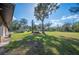 Lush backyard with mature trees and a well-maintained lawn, offering ample space at 4075 Davis Rd, Mulberry, FL 33860