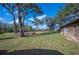 Expansive backyard with mature trees and a well-kept lawn, offering ample outdoor space at 4075 Davis Rd, Mulberry, FL 33860