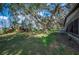 Spacious backyard featuring mature trees and a well-maintained lawn, showcasing lush greenery at 4075 Davis Rd, Mulberry, FL 33860