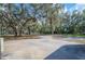 Wide driveway offering ample parking space with mature trees shading the area at 4075 Davis Rd, Mulberry, FL 33860