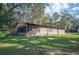 Exterior side view of the house, showcasing the siding and well-maintained surroundings at 4075 Davis Rd, Mulberry, FL 33860