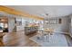 Open kitchen and dining area featuring exposed wood beams, wood floors, and a stylish island with seating at 4075 Davis Rd, Mulberry, FL 33860