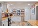 Beautiful kitchen with white cabinets, brick backsplash, stainless steel appliances and wood countertops at 4075 Davis Rd, Mulberry, FL 33860