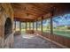 Screened-in sunroom with stone floor, wood ceiling and stone fireplace at 4075 Davis Rd, Mulberry, FL 33860