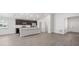 Spacious living area showcasing a contemporary kitchen with sleek cabinetry, stainless steel appliances, and a large island at 4522 Rapallo Ave, Winter Haven, FL 33884