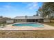 A refreshing in-ground swimming pool with a large concrete patio and fenced yard at 4550 Old Colony Rd, Mulberry, FL 33860