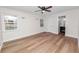 Bright bedroom with wood floors, ceiling fan, two windows and en suite bathroom at 4550 Old Colony Rd, Mulberry, FL 33860