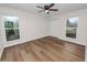 Bright bedroom featuring wood flooring, natural light, ceiling fan and closet at 4550 Old Colony Rd, Mulberry, FL 33860