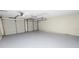 An attached two car garage with white doors and peg board at 4550 Old Colony Rd, Mulberry, FL 33860