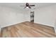 A bright living room with new flooring leading to the kitchen area, creating a cozy space at 4550 Old Colony Rd, Mulberry, FL 33860