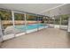 View of the screened-in lanai with tiled floors, overlooking the pool at 4550 Old Colony Rd, Mulberry, FL 33860