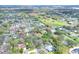 Gorgeous aerial shot of a quiet residential neighborhood with mature trees and well-maintained lawns near open fields at 4613 Little Grove Ln, Lakeland, FL 33813