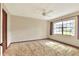 Bright bedroom featuring a ceiling fan, a window, and warm lighting, offering a comfortable retreat at 4613 Little Grove Ln, Lakeland, FL 33813