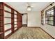 Cozy bedroom with built-in bookshelves, a ceiling fan, and a window, offering a peaceful retreat at 4613 Little Grove Ln, Lakeland, FL 33813