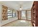 Inviting bedroom featuring built-in bookshelves, large windows with natural light, and a ceiling fan at 4613 Little Grove Ln, Lakeland, FL 33813