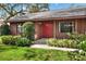 Close up of charming home with a red front door and professional landscaping at 4613 Little Grove Ln, Lakeland, FL 33813