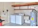 Garage with laundry machines, utility sink, water heater, and overhead storage at 4613 Little Grove Ln, Lakeland, FL 33813