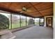 Screened-in sunroom with wood-paneled ceiling, ceiling fan, and outside access at 4613 Little Grove Ln, Lakeland, FL 33813