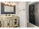 Elegant bathroom featuring a decorative vanity, detailed mirror, and shower at 4624 Kings Point Ct, Lakeland, FL 33813