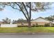 A charming single-story home features a well-manicured lawn, mature trees, and a privacy fence for a peaceful setting at 4624 Kings Point Ct, Lakeland, FL 33813