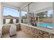 Enclosed porch with view of the pergola and pool at 4624 Kings Point Ct, Lakeland, FL 33813