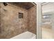 Tiled walk-in shower and door that leads to a patio and pool area at 4624 Kings Point Ct, Lakeland, FL 33813