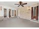 Bright sun room with stone accent wall, ceiling fan and access to the outdoors at 4624 Kings Point Ct, Lakeland, FL 33813