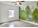 Bright bedroom featuring a charming forest mural, ample natural light, and tile floors, great for a nature lover at 477 Kensington View Dr, Winter Haven, FL 33880