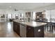 Open kitchen with island and stainless steel dishwasher in an open concept living and dining area at 477 Kensington View Dr, Winter Haven, FL 33880