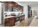 Kitchen featuring stainless steel appliances, dark wood cabinets, and an open layout at 477 Kensington View Dr, Winter Haven, FL 33880