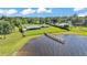 Waterfront property with a long pier and beautiful lake views from an aerial perspective on a bright and sunny day at 5418 Cooper Ln, Fort Meade, FL 33841