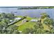 Scenic aerial view of waterfront homes with luscious green lawns and serene lake views at 5418 Cooper Ln, Fort Meade, FL 33841