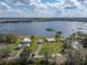 Picturesque aerial view of waterfront homes with sprawling lawns on a sunny day by the lake at 5418 Cooper Ln, Fort Meade, FL 33841