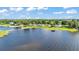 Expansive aerial view showcasing a serene lake with multiple properties, each boasting private docks along the shoreline at 5418 Cooper Ln, Fort Meade, FL 33841