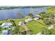 Waterfront homes featuring a green lawn leading to a serene lake backdrop in an aerial view at 5418 Cooper Ln, Fort Meade, FL 33841