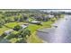 Panoramic aerial showcasing waterfront property with multiple dwellings and private docks on a lush, green landscape at 5418 Cooper Ln, Fort Meade, FL 33841