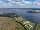 Scenic aerial shot showcases homes along the serene lakefront with lush greenery and expansive lawns at 5418 Cooper Ln, Fort Meade, FL 33841