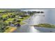 Aerial view of lakefront houses with docks and lovely landscapes, providing a peaceful waterfront lifestyle at 5418 Cooper Ln, Fort Meade, FL 33841