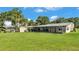 A spacious backyard with a covered patio, storage shed, and outdoor cooking area at 5418 Cooper Ln, Fort Meade, FL 33841