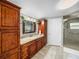 Bathroom features custom wood cabinets, granite counters, tiled floors and a large shower at 5418 Cooper Ln, Fort Meade, FL 33841