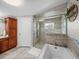 Bathroom boasts modern soaking tub, enclosed tiled shower, and wooden storage cabinets at 5418 Cooper Ln, Fort Meade, FL 33841