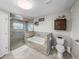 Luxurious bathroom featuring a glass-enclosed shower, soaking tub, and stylish fixtures at 5418 Cooper Ln, Fort Meade, FL 33841