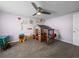 Bedroom showcases a playhouse, toys, carpet, and a ceiling fan at 5418 Cooper Ln, Fort Meade, FL 33841