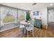 Cozy dining area featuring a white table and chairs with large windows offering a view of the outdoors at 5418 Cooper Ln, Fort Meade, FL 33841