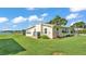 A charming home exterior surrounded by a lush green lawn and lake views at 5418 Cooper Ln, Fort Meade, FL 33841