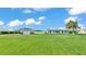 Quaint home with a detached garage and a large lawn surrounded by mature trees at 5418 Cooper Ln, Fort Meade, FL 33841