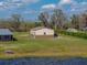 Exterior of home with view of lake and detached garage at 5418 Cooper Ln, Fort Meade, FL 33841